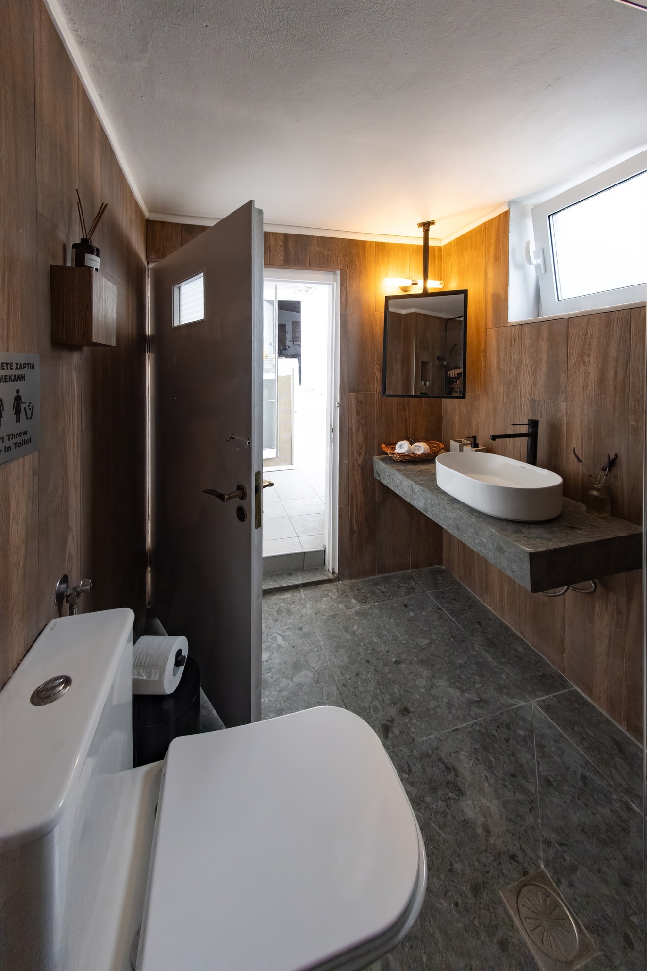 Renovated bathroom with rain shower and stone counter